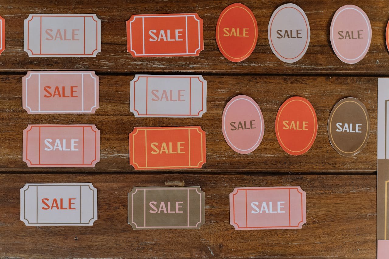 gallery-1 Various sale tags on a wooden surface ideal for retail marketing and promotions.